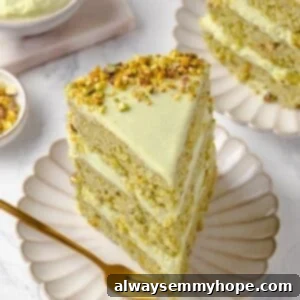 Slice of vegan pistachio cake on plate with fork