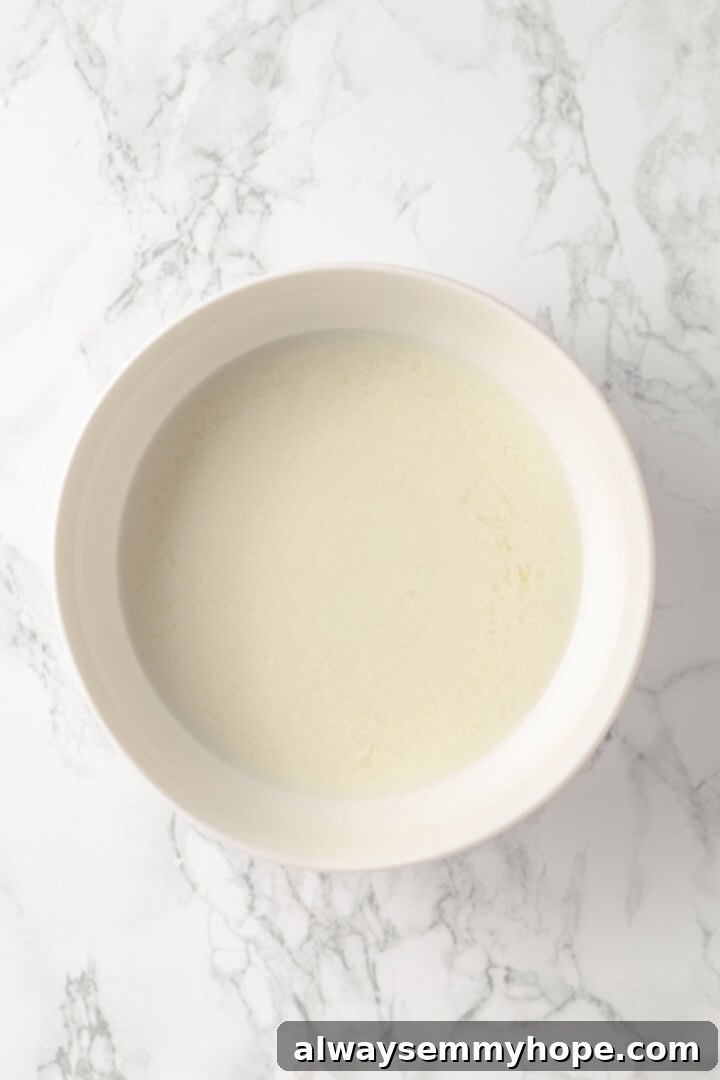Overhead view of liquid ingredients for pistachio cake before adding coloring