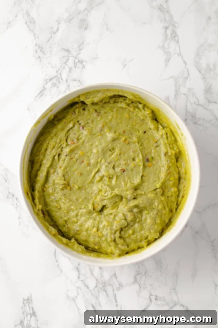 Overhead view of pistachio cake batter in bowl