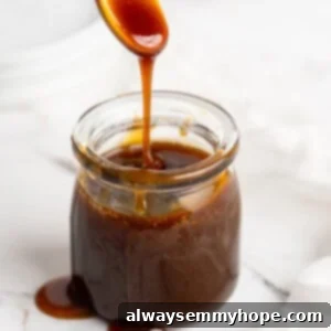 Spoon drizzling date syrup into jar
