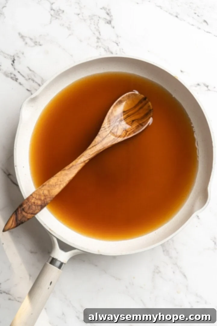 Date liquid in a pan before reducing, appearing thinner and lighter in color