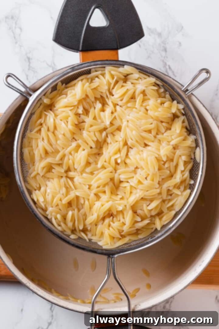 Draining cooked orzo in colander