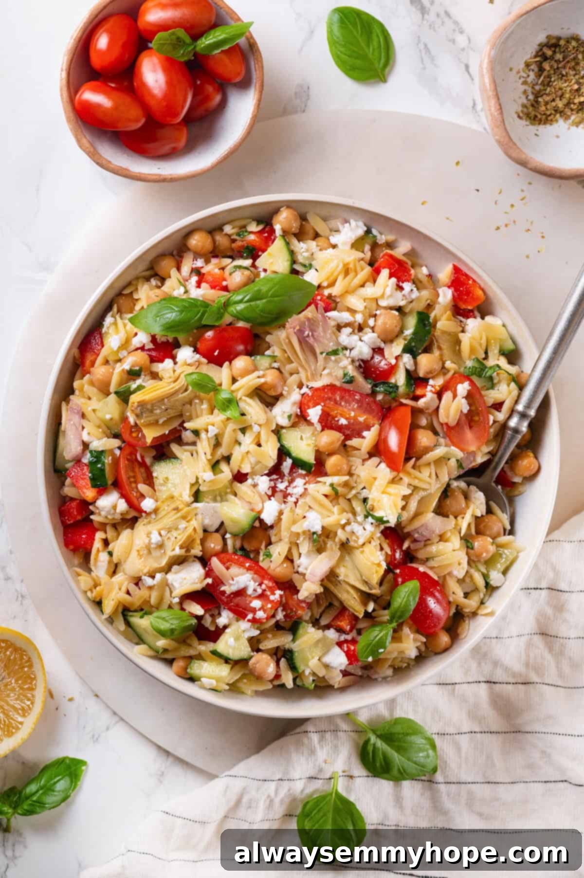 Overhead view of vegan orzo pasta salad with spoon