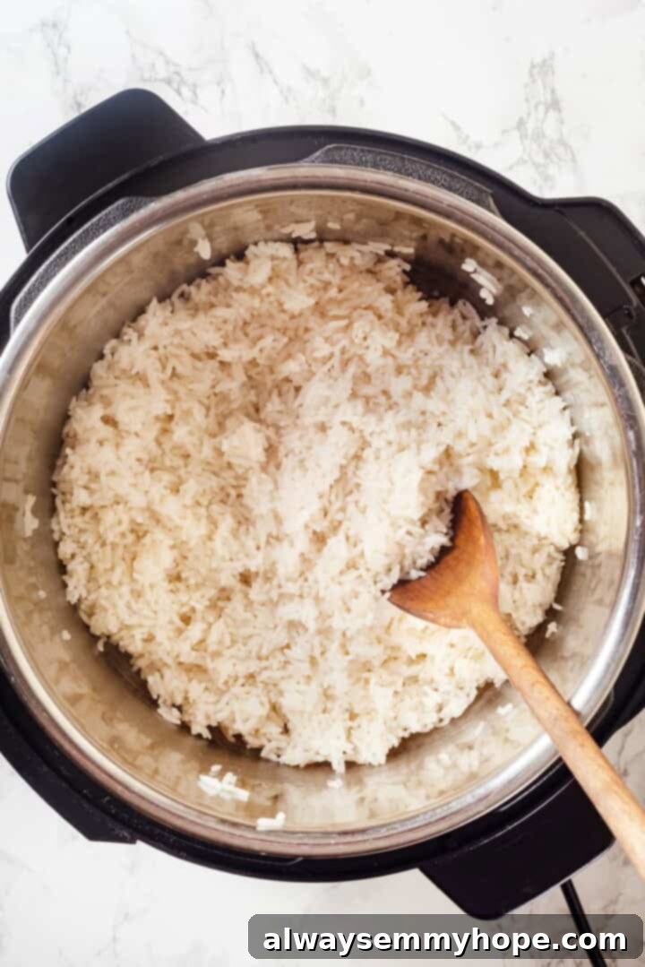 Overhead view of jasmine rice in Instant Pot with wooden spoon