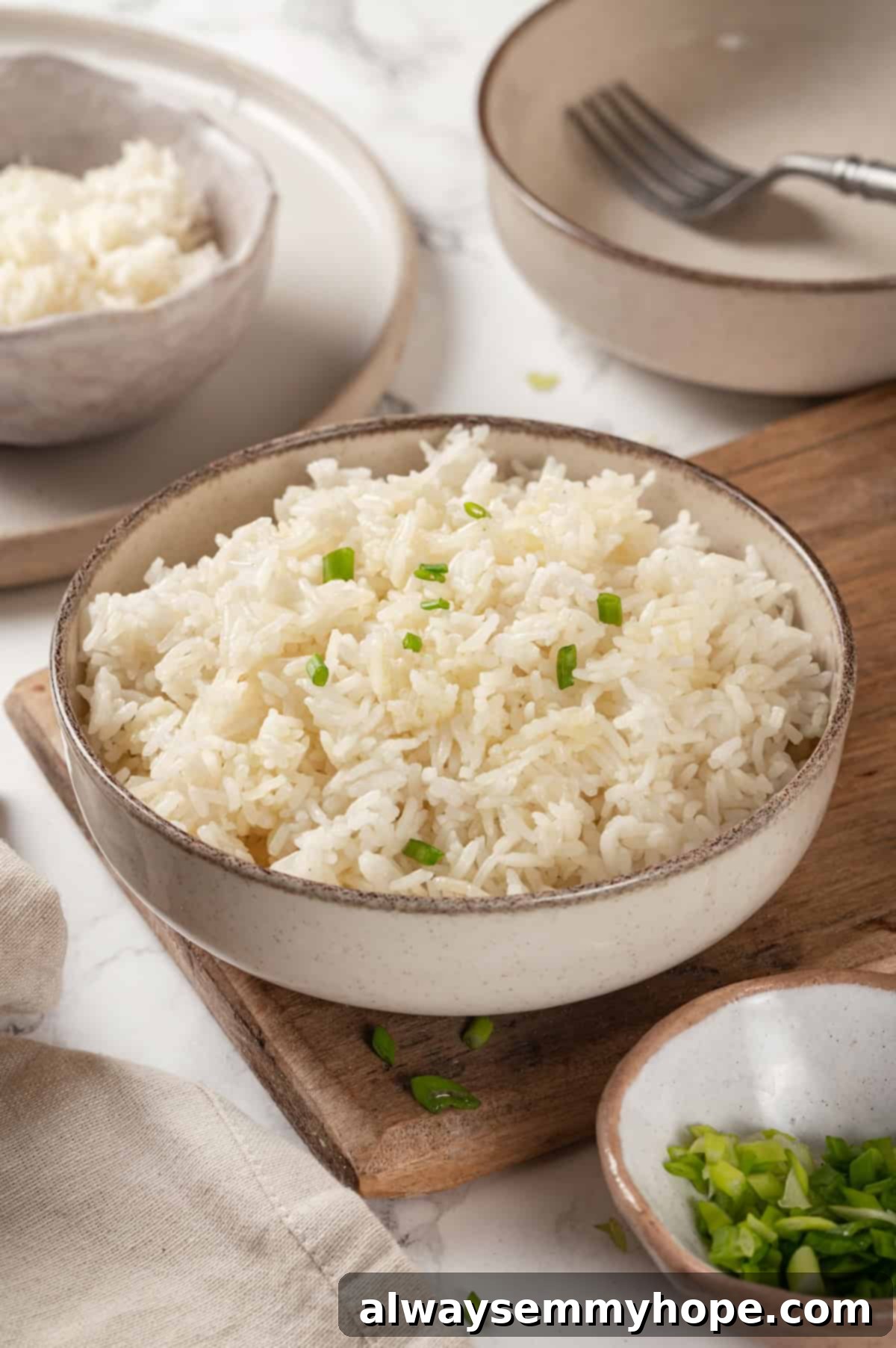 Bowl of Instant Pot jasmine rice with green onions for garnish