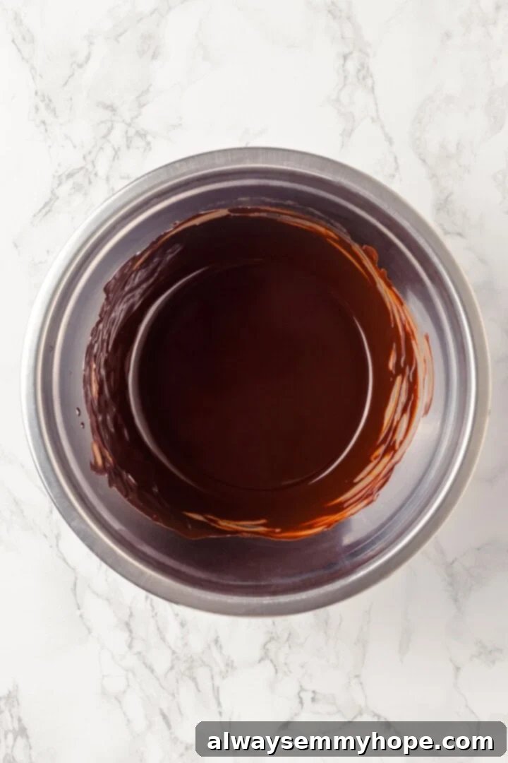Overhead view of melted vegan butter and chocolate in bowl