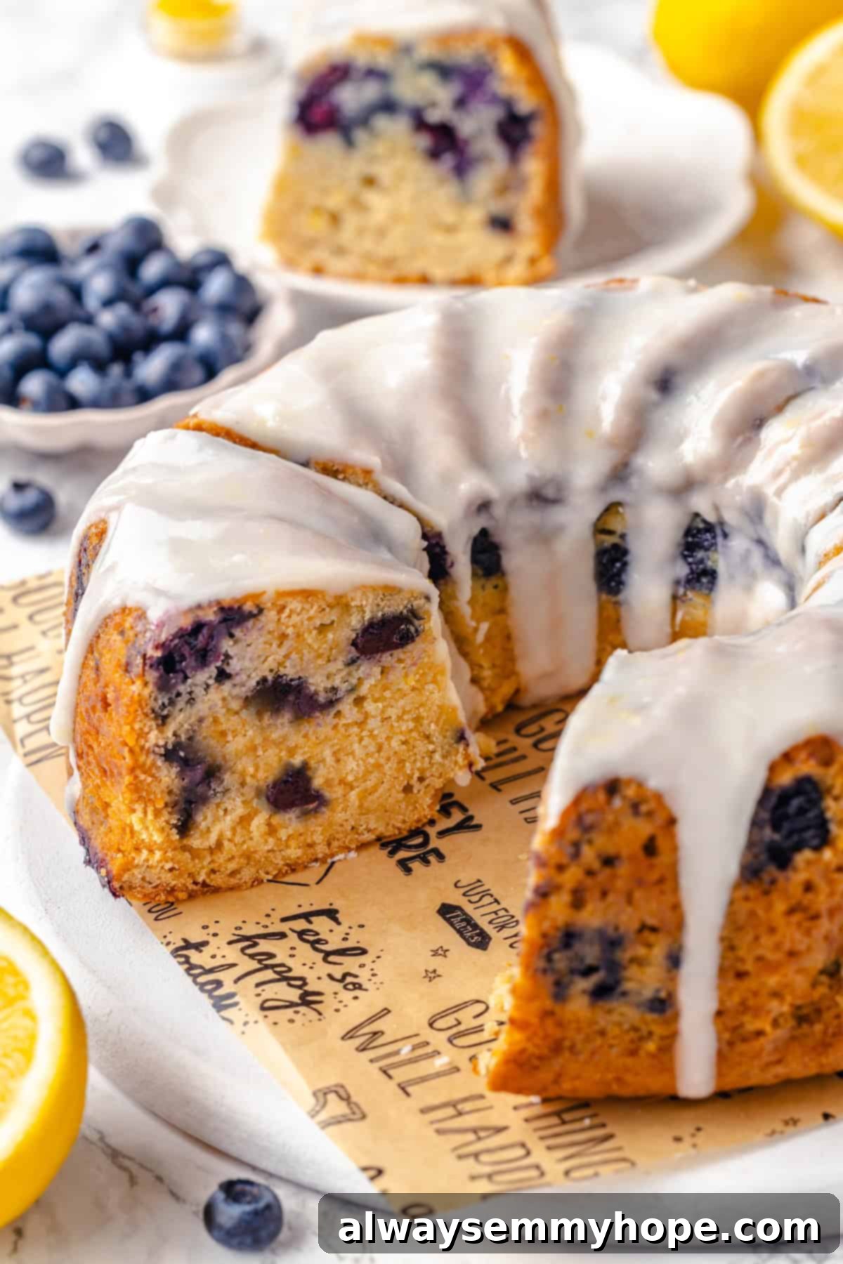 Enjoy this moist vegan lemon blueberry Bundt cake, brimming with bright lemon and juicy berries, ideal for summer gatherings. A perfectly sliced vegan lemon blueberry Bundt cake on a serving platter, with several pieces already removed, showcasing its moist crumb and vibrant blueberries.