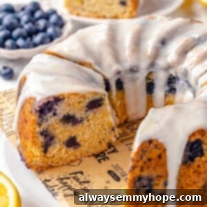Sunshine Lemon Blueberry Bundt 2 Sliced lemon blueberry Bundt cake on platter with a few pieces removed
