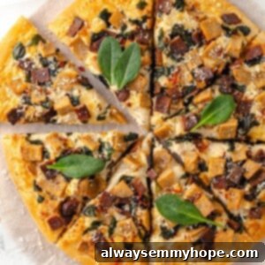 Creamy Alfredo Pizza 2 Overhead view of whole Alfredo sauce pizza cut into slices