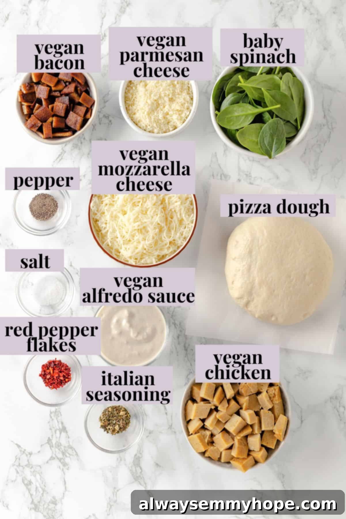 A creamy sauce makes this Alfredo sauce pizza taste indulgent, but it’s vegan! Plant-based chicken and bacon take this recipe over the top. Overhead view of all fresh ingredients for Alfredo sauce pizza laid out on a table