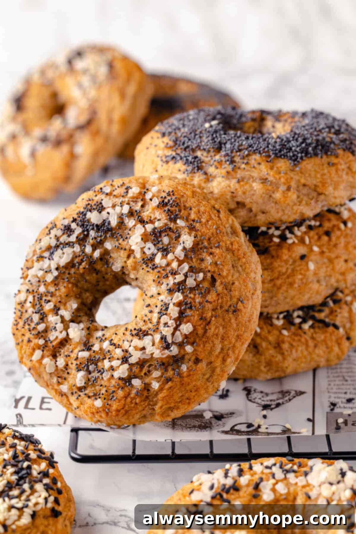 These homemade gluten-free bagels are chewy, delicious, and perfect for finishing with all your favourite toppings. So easy to make too! Stack of 3 gluten-free bagels with another leaning against it