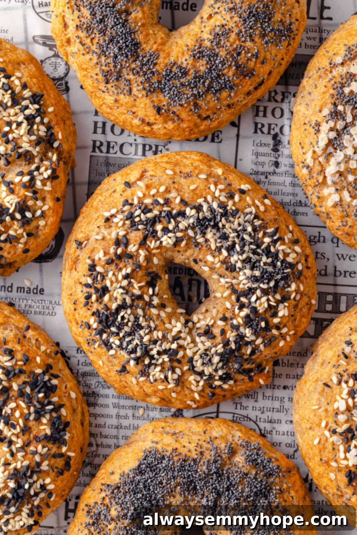 These homemade gluten-free bagels are chewy, delicious, and perfect for finishing with all your favourite toppings. So easy to make too! Overhead view of gluten-free bagels on parchment paper