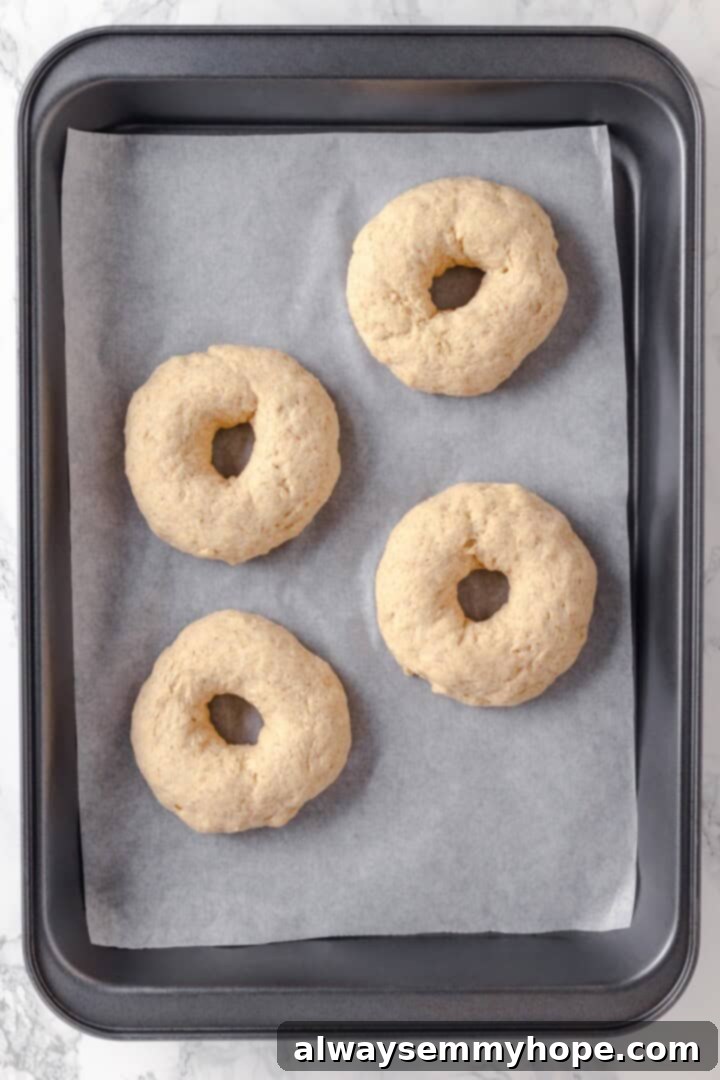 These homemade gluten-free bagels are chewy, delicious, and perfect for finishing with all your favourite toppings. So easy to make too! Overhead view of gluten-free bagels before boiling