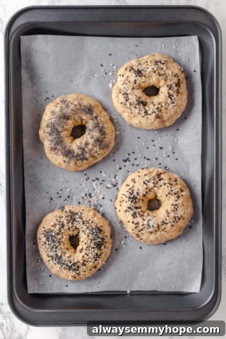 These homemade gluten-free bagels are chewy, delicious, and perfect for finishing with all your favourite toppings. So easy to make too! Overhead view of unbaked gluten-free bagels