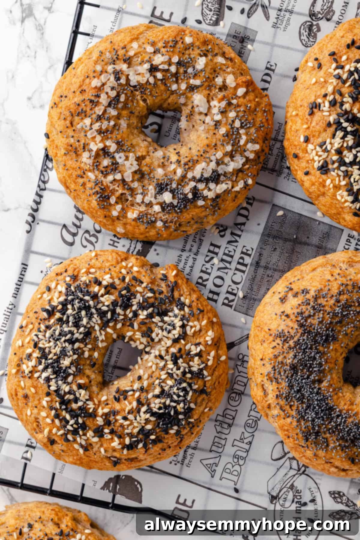 These homemade gluten-free bagels are chewy, delicious, and perfect for finishing with all your favourite toppings. So easy to make too! Overhead view of gluten-free bagels on wire rack