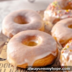 Homemade air fryer donuts on parchment-lined board