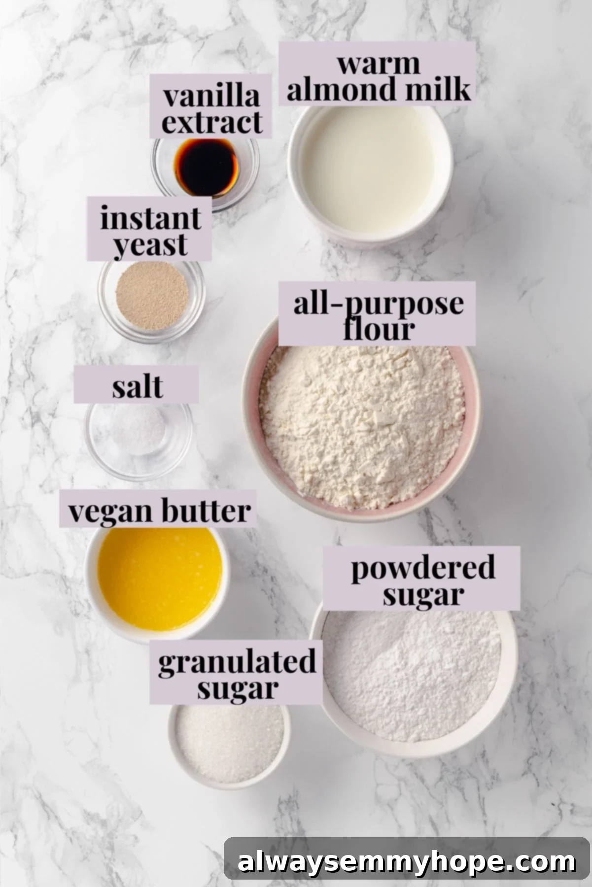 Overhead view of all the simple ingredients laid out for making air fryer donuts, including flour, sugar, yeast, milk, and butter.