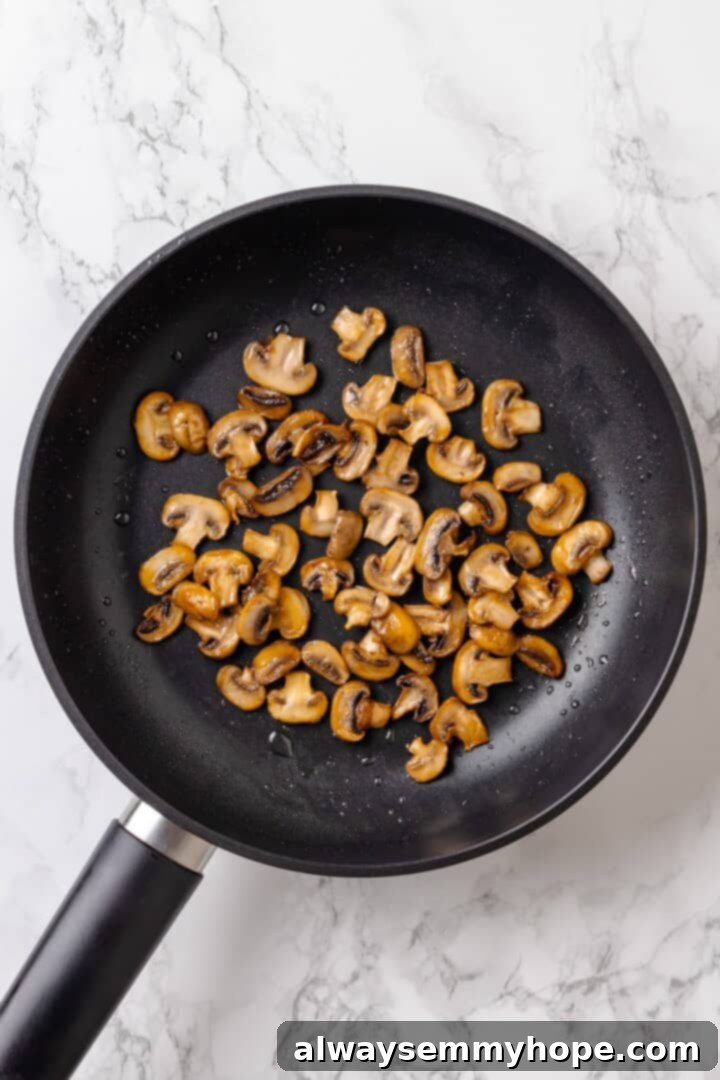 Overhead view of sauteed mushrooms in skillet