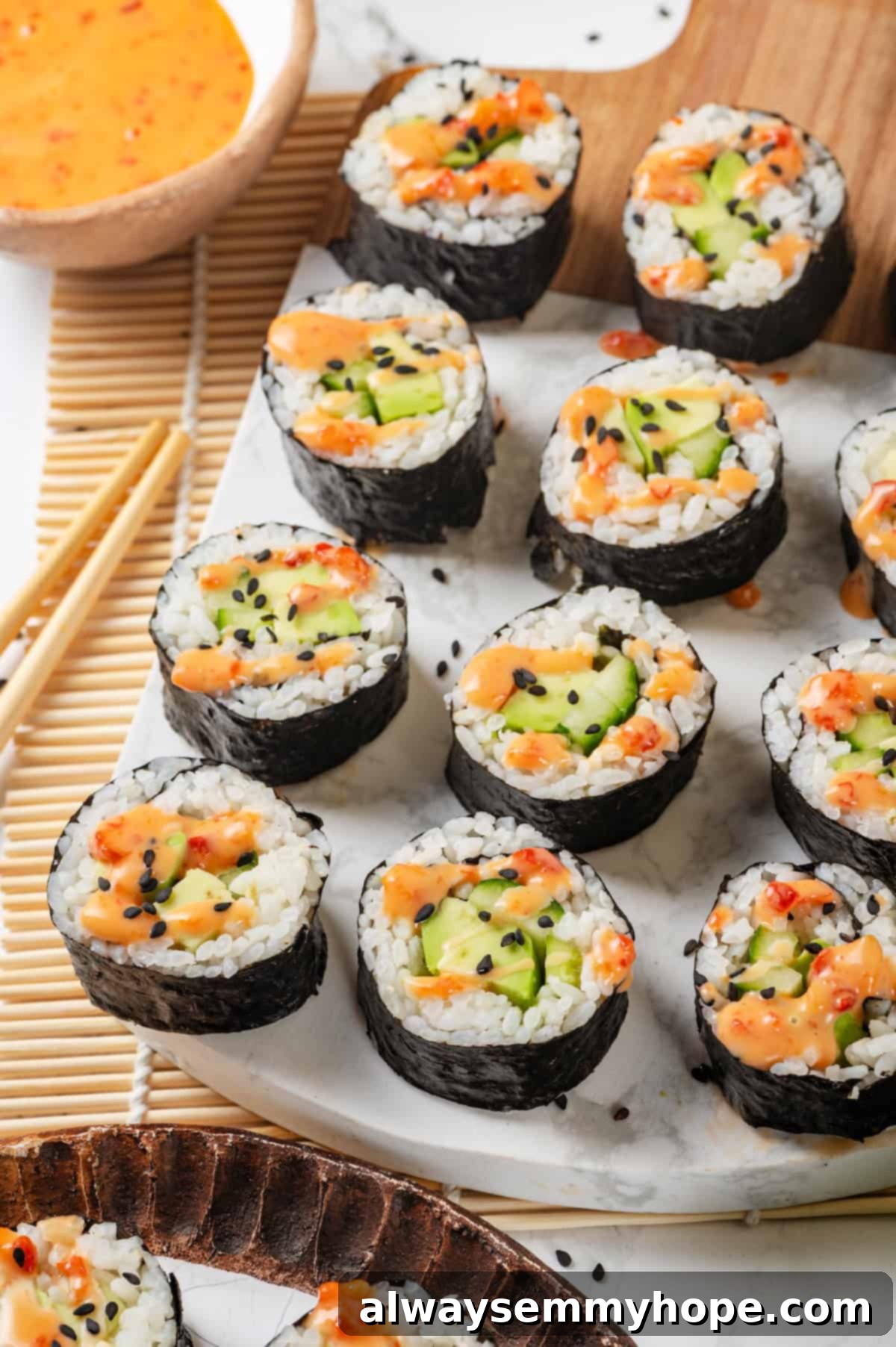 Avocado sushi rolls arranged on marble serving board