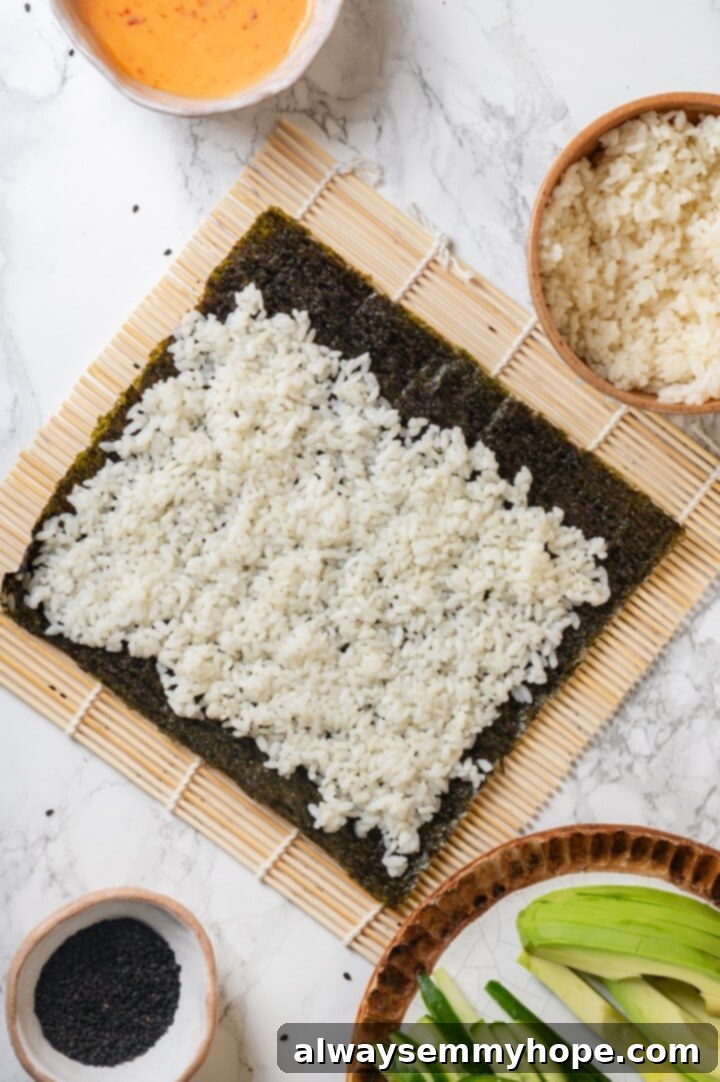 Overhead view of sushi rice on sheet of nori