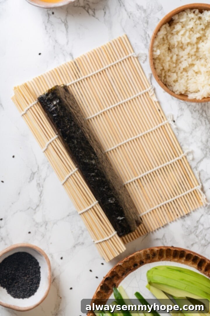 Rolled up avocado sushi on bamboo mat