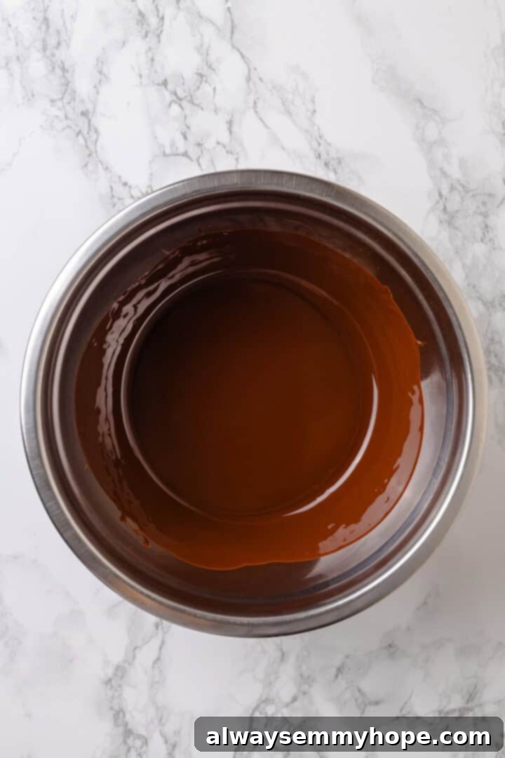 With an Oreo crust, decadent vegan mousse filling, and coconut whipped cream, this chocolate mousse pie recipe is absolutely irresistible! Overhead view of melted dark chocolate and coconut oil in a bowl