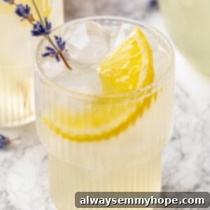 Lavender lemonade in glass with lemon slice and lavender sprig