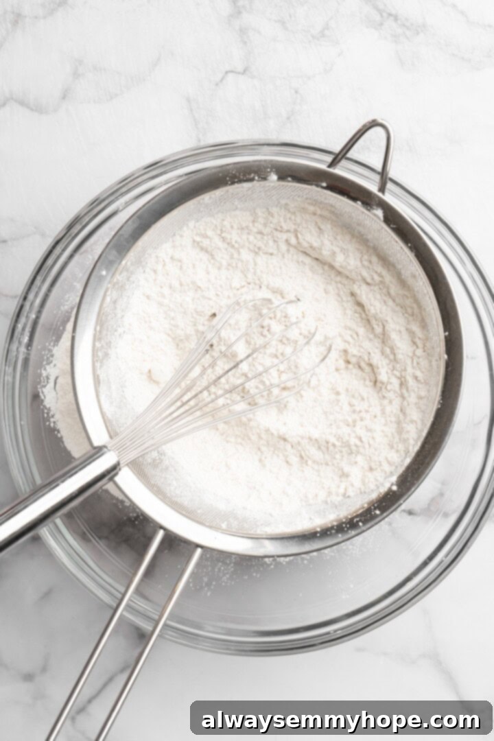 Sifting dry ingredients into mixing bowl