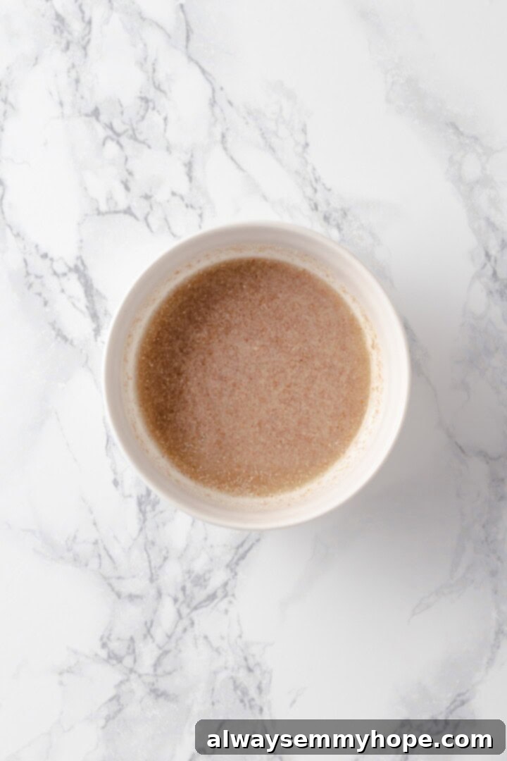 This baked oatmeal recipe is an easy meal prep breakfast! It's hearty and wholesome, with juicy berries and crunchy walnuts in every bite. Overhead view of flax egg mixture in bowl thickening