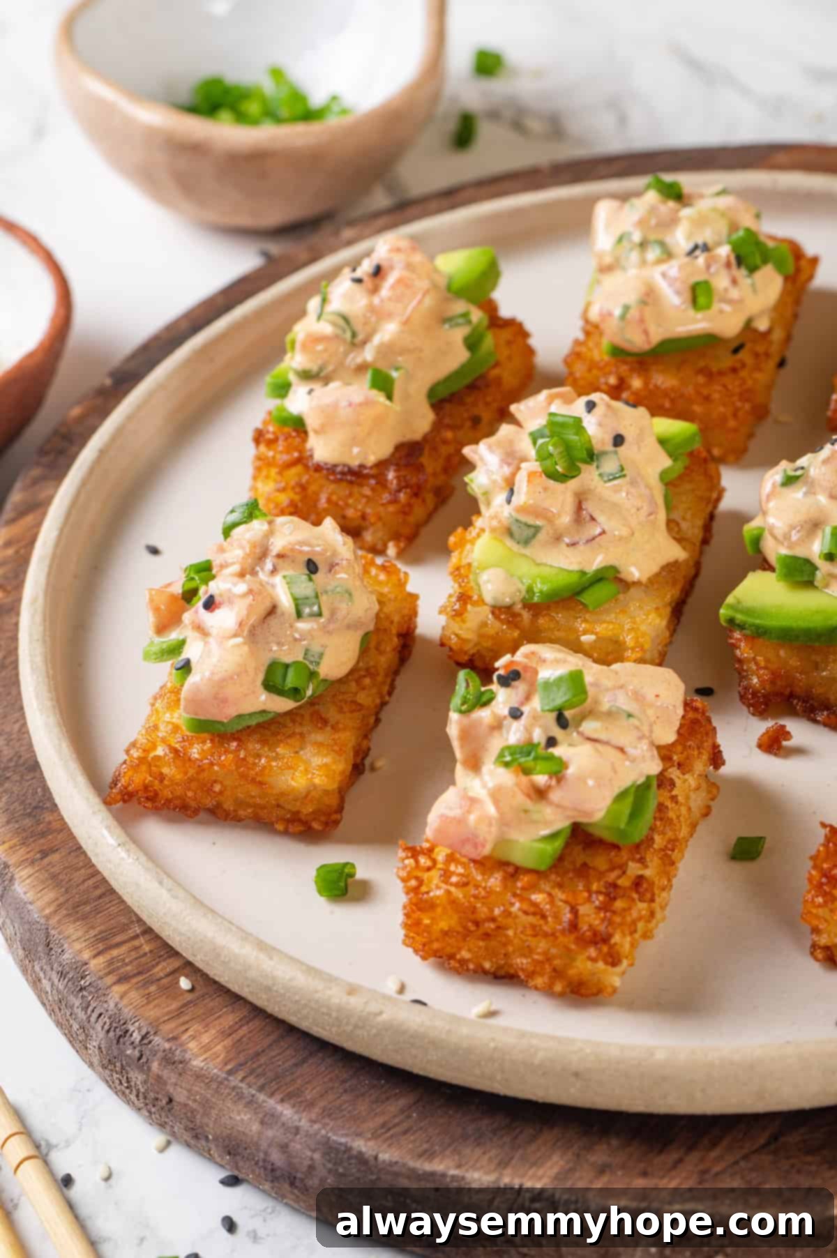 Plate of crispy rice cakes topped with creamy vegan tuna