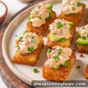 Plate of crispy rice cakes topped with creamy vegan tuna