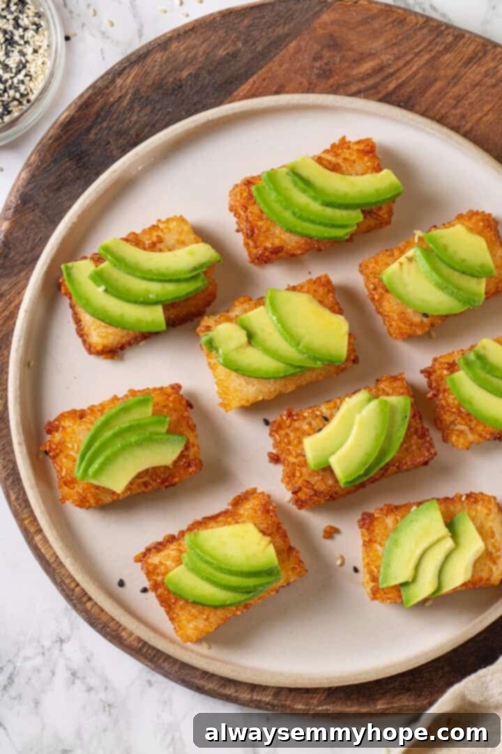 Overhead view of crispy rice cakes topped with avocado slices