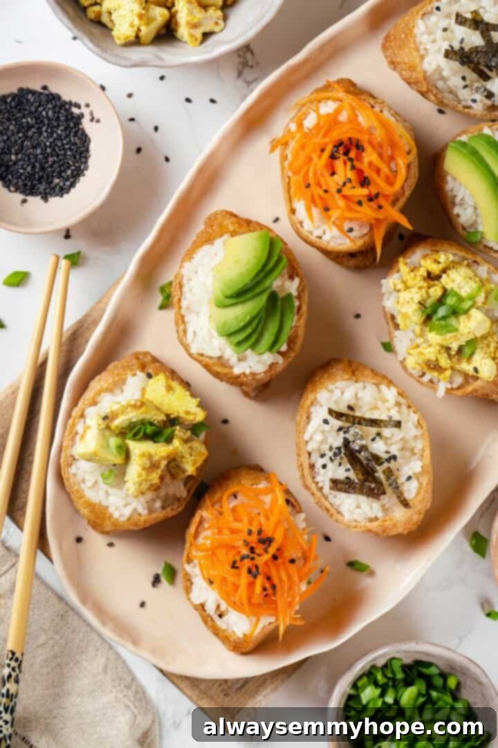 This inari sushi recipe tucks tangy sushi rice into tofu pockets with toppings like avocado, spicy carrots, and tofu scramble. Easy and fun! Overhead view of inari sushi on platter with vegan toppings