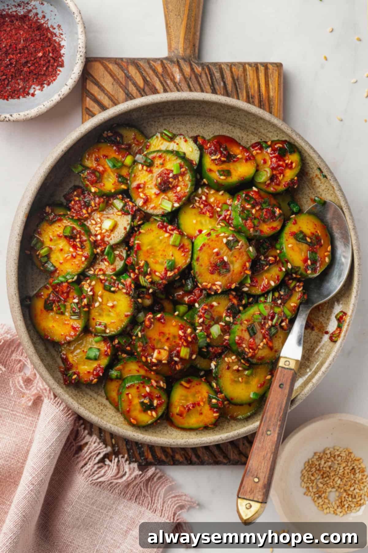 Crisp, refreshing, and full of bold flavour, this spicy Korean cucumber salad recipe is an easy side dish you’ll make all summer long! Overhead view of Korean cucumber salad in bowl with spoon, vibrant and ready to eat