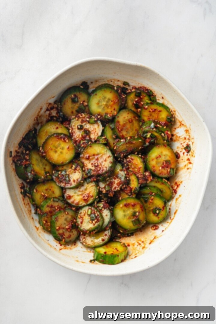 Crisp, refreshing, and full of bold flavour, this spicy Korean cucumber salad recipe is an easy side dish you’ll make all summer long! Overhead view of Korean cucumber salad in a bowl, fully dressed and ready to be served
