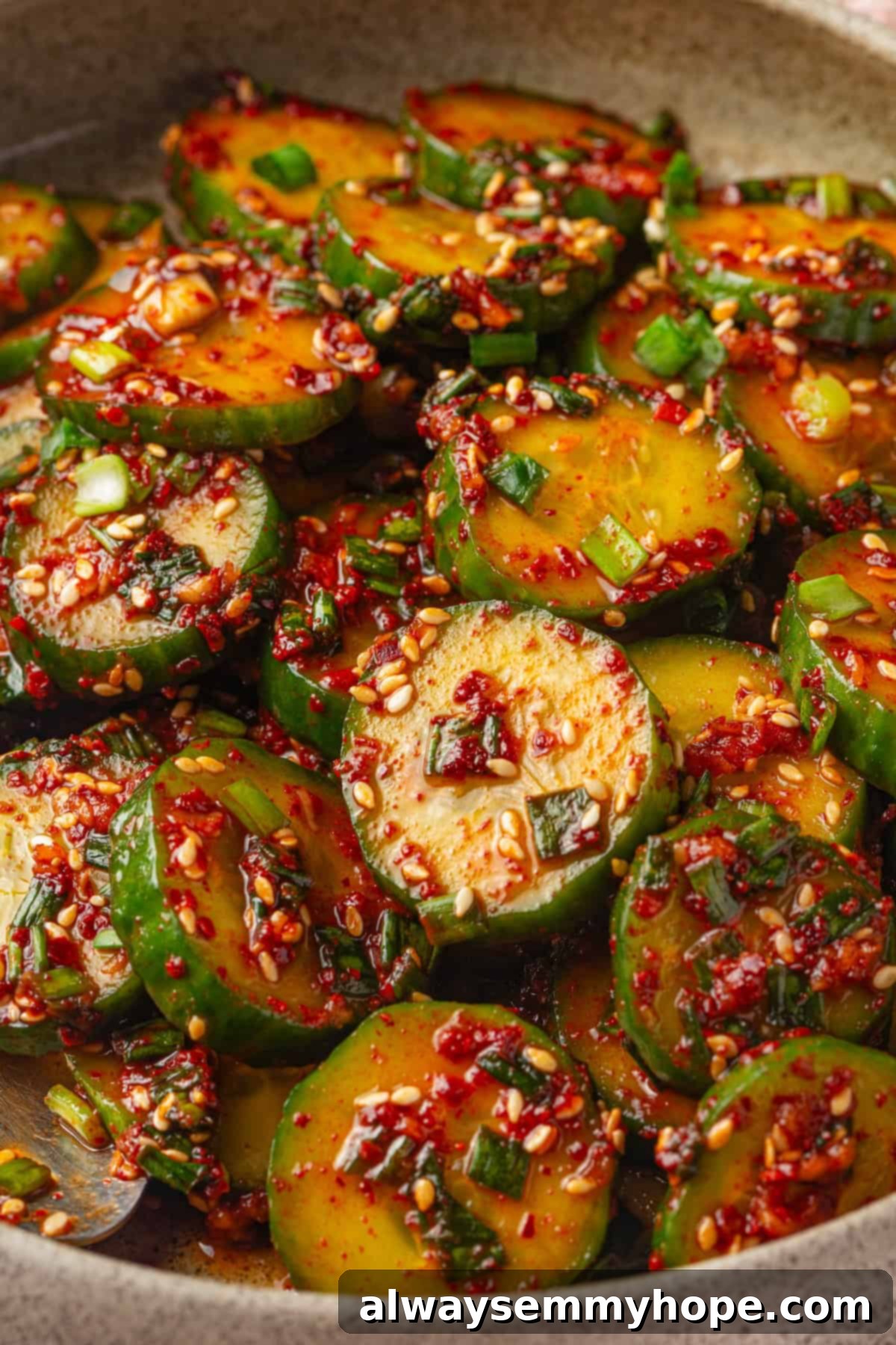 Crisp, refreshing, and full of bold flavour, this spicy Korean cucumber salad recipe is an easy side dish you’ll make all summer long! Closeup of Korean cucumber salad in a vibrant bowl, showing texture and color