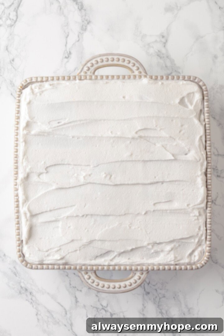 This strawberry icebox cake is cool, creamy, and super easy to make, with vegan whipped cream, fresh strawberries, and graham crackers. Yum! Overhead view of strawberry icebox cake before adding strawberries for garnish