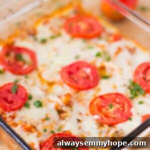 Cheesy Cauliflower Pizza Bake 5 Cheesy casserole in a glass dish, with a golden-brown, bubbly top.