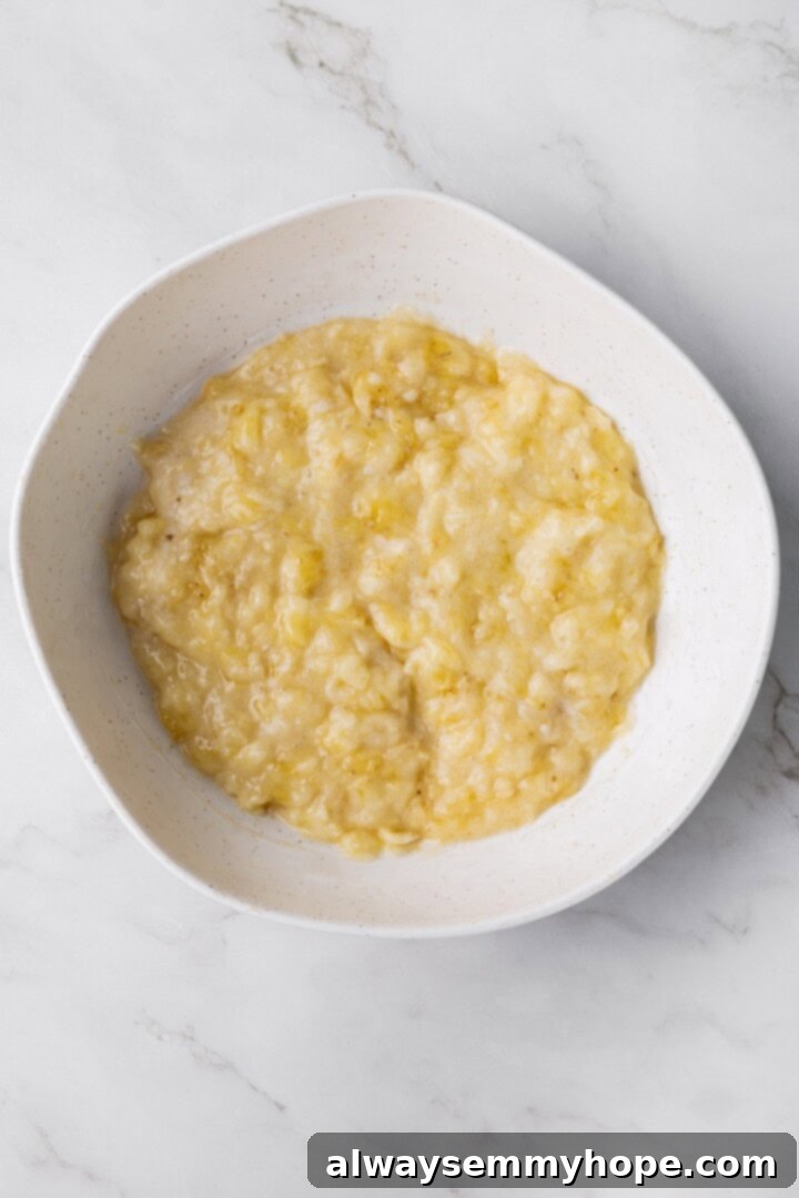 Overhead view of mashed banana in bowl