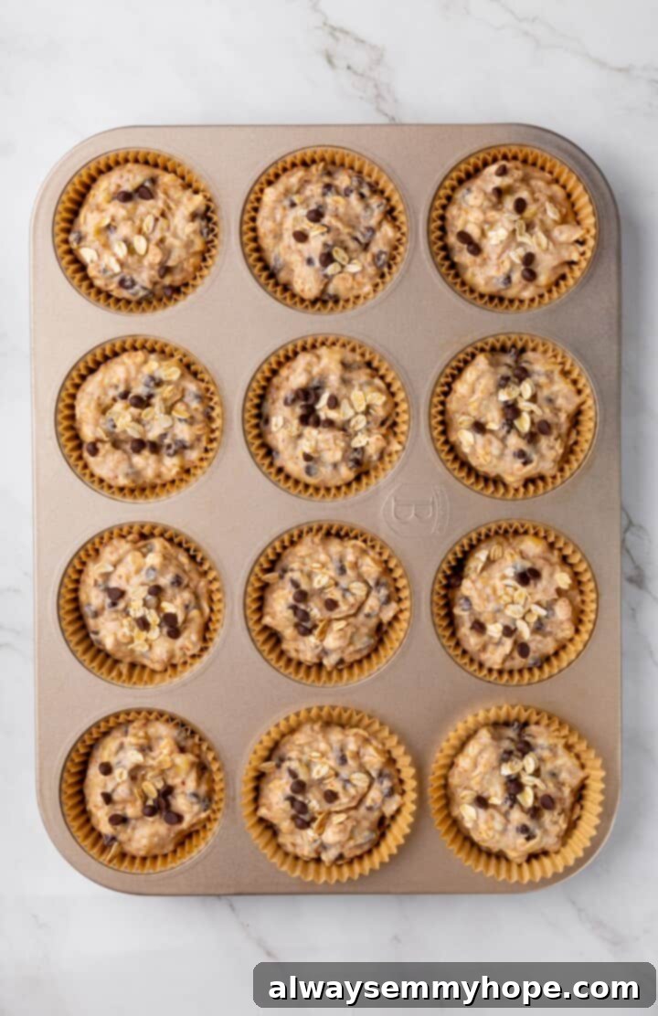 Overhead view of batter for banana oatmeal muffins in pan