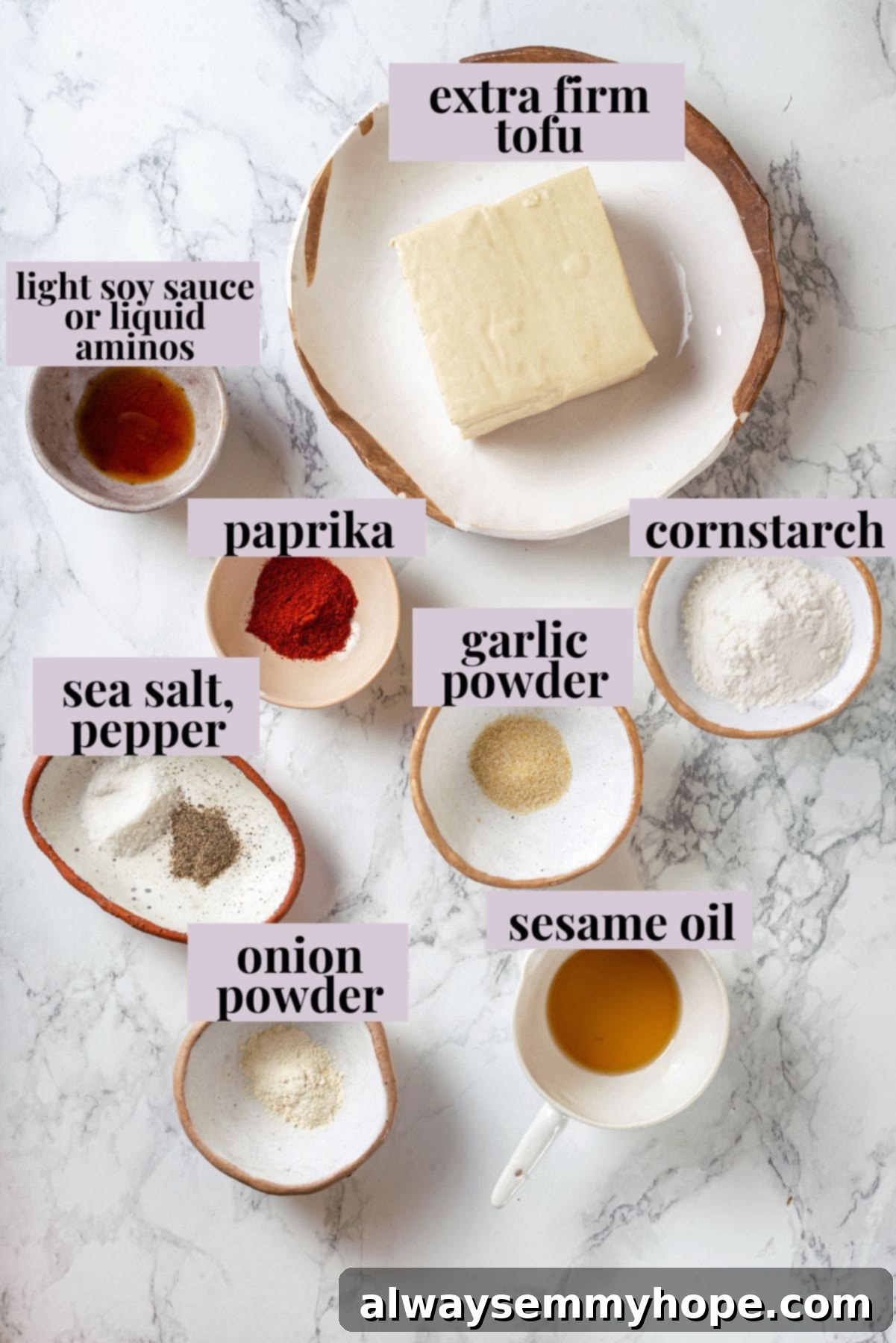 Crispy air fried tofu is layered with crunchy pickled veggies on crusty baguette to make this fresh and flavourful vegan Tofu Banh Mi recipe! Overhead view of ingredients for crispy air fryer tofu for banh mi, including tofu block, soy sauce, and spices