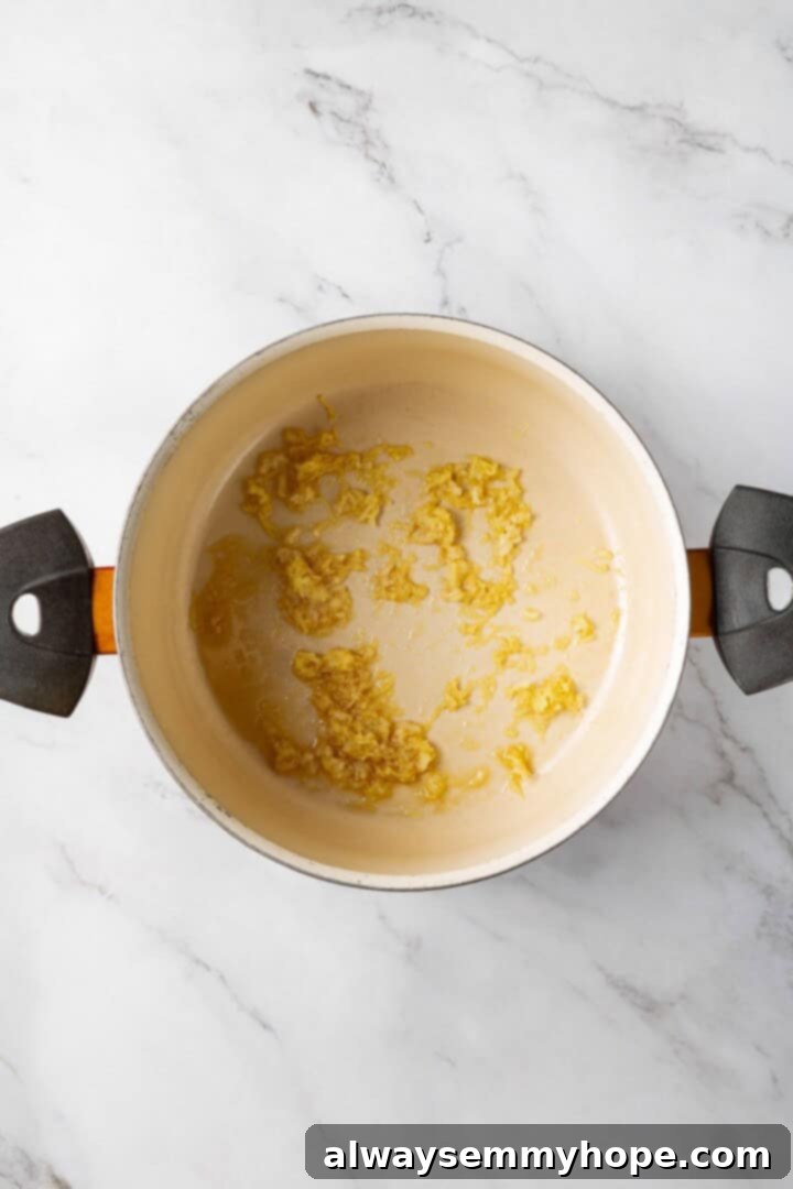 This spicy Kimchi Ramen is ridiculously easy, and the combination of tofu, kimchi, and shiitakes makes it a satisfying, flavour-packed meal! Minced ginger and garlic sizzling in a pot with sesame oil, releasing their fragrant aromas.