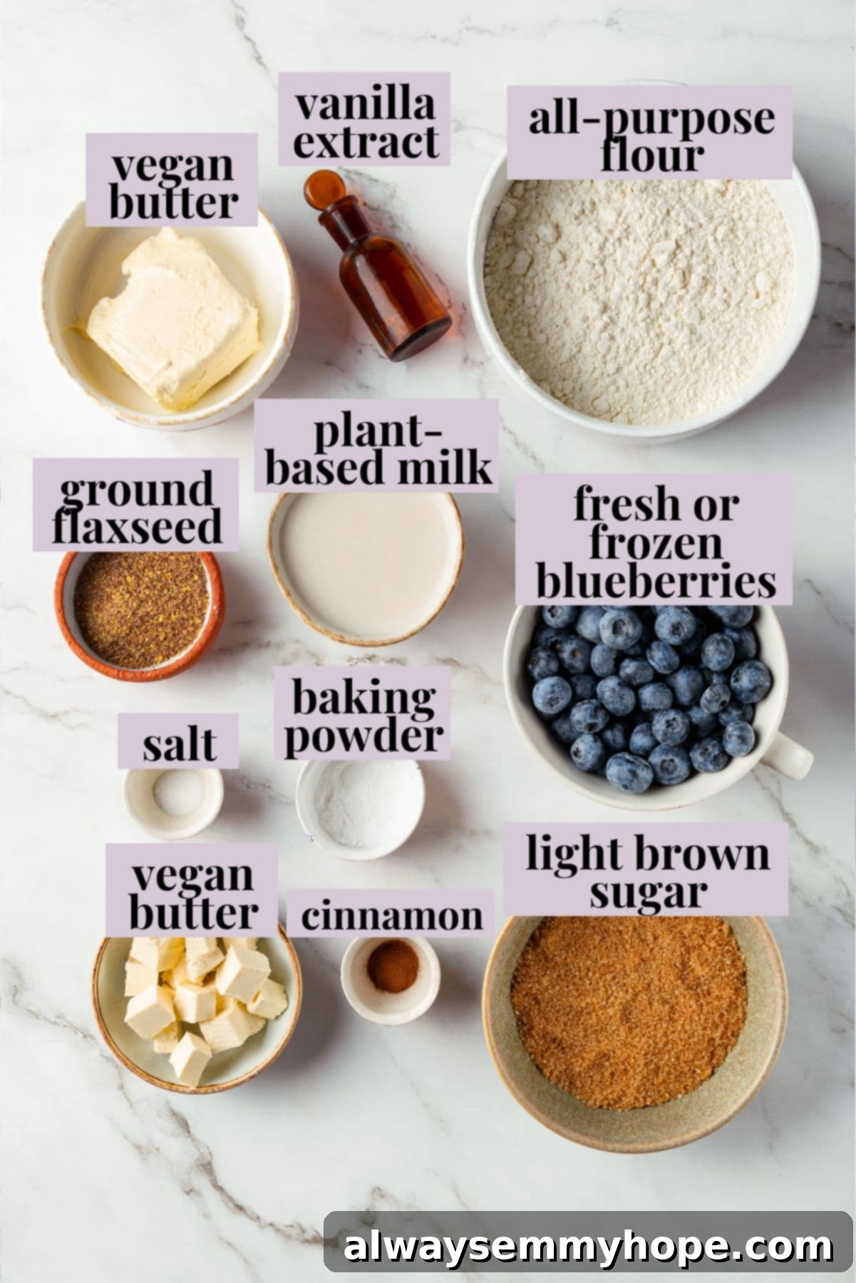 A little bit like coffee cake, this Blueberry Buckle is loaded with berries, then topped with brown sugar cinnamon streusel. So delicious! Overhead view of fresh ingredients for vegan blueberry buckle laid out on a kitchen counter, including flour, sugar, butter, and blueberries.