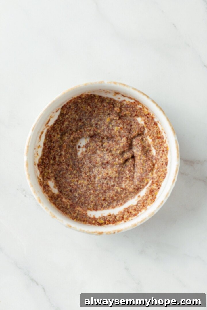 A little bit like coffee cake, this Blueberry Buckle is loaded with berries, then topped with brown sugar cinnamon streusel. So delicious! Overhead view of ground flaxseed mixed with plant milk in a small bowl, forming a flax egg.