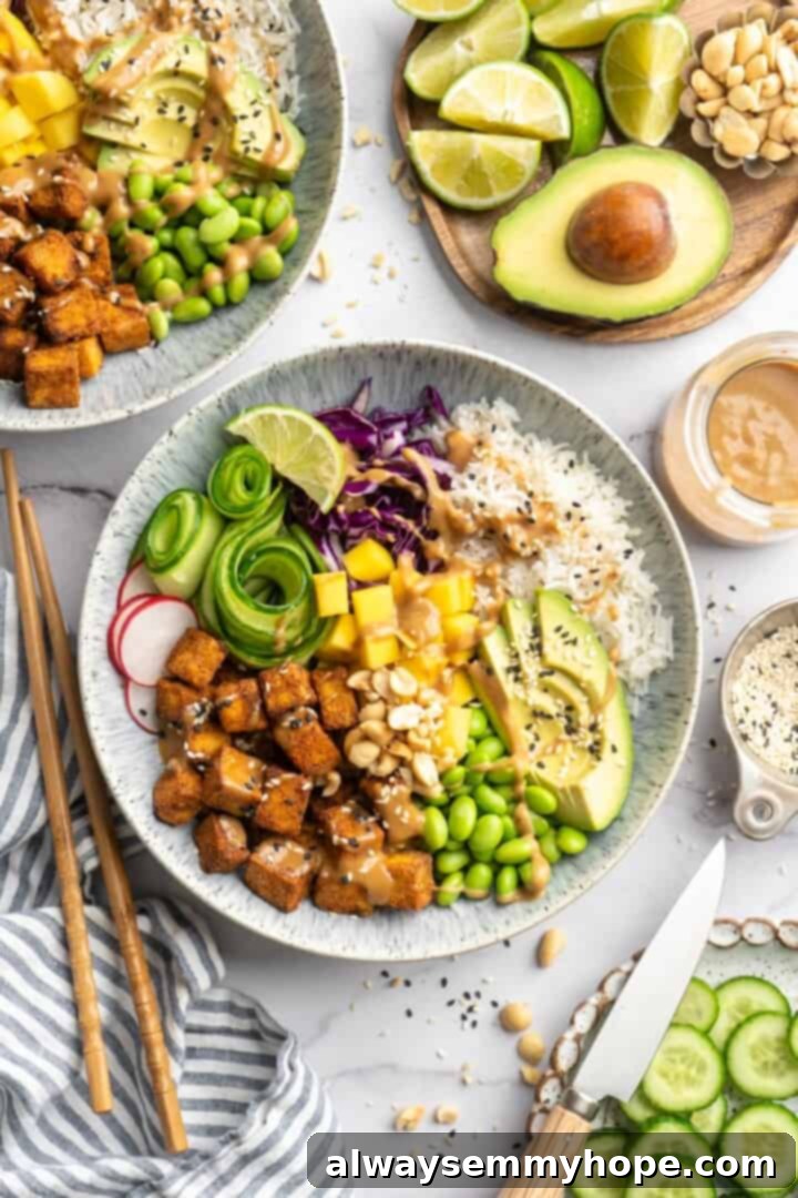 Assembling the Crispy Peanut Tofu Bowls Overhead view of a fully assembled crispy peanut tofu bowl, laden with fresh vegetables, fluffy rice, and generous drizzles of creamy peanut sauce, ready to be enjoyed.