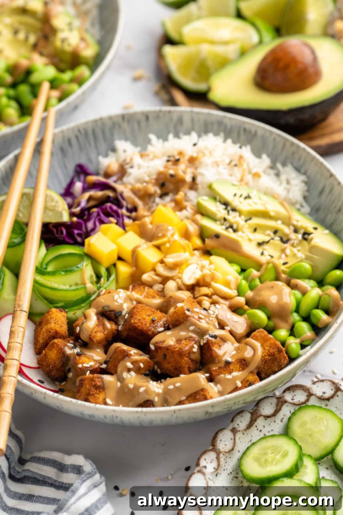 Peanut Tofu Bowl Ready to Eat A close-up shot of a prepared peanut tofu bowl, showing crispy tofu, various colorful vegetables, and rice, with a pair of chopsticks resting on the side, inviting you to dig in.