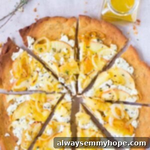 Caramelized Onion and Apple Goat Cheese Pizza 2 Top down shot of slices of goat cheese, caramelized onion, and apple pizza on a table, ready to be served, with a small bowl of olive oil on the side.