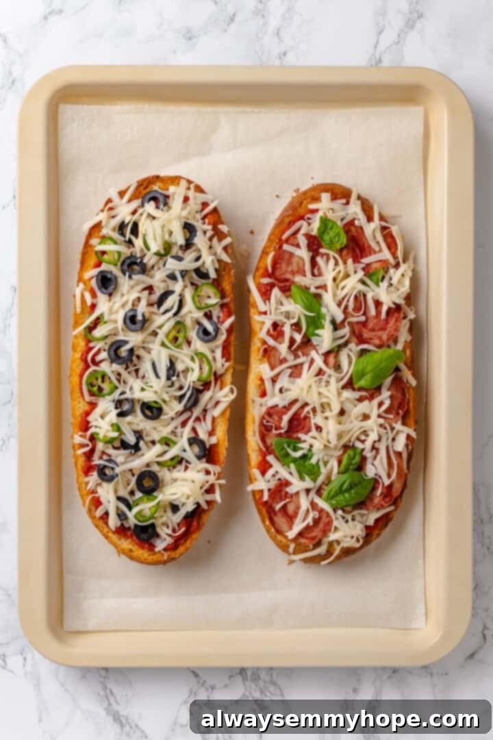 This vegan French Bread Pizza recipe is cheesy, easy and that thick, toasty base puts regular crust to shame. I’ve got two topping options! Two unbaked vegan French bread pizzas on a sheet pan, ready for the oven
