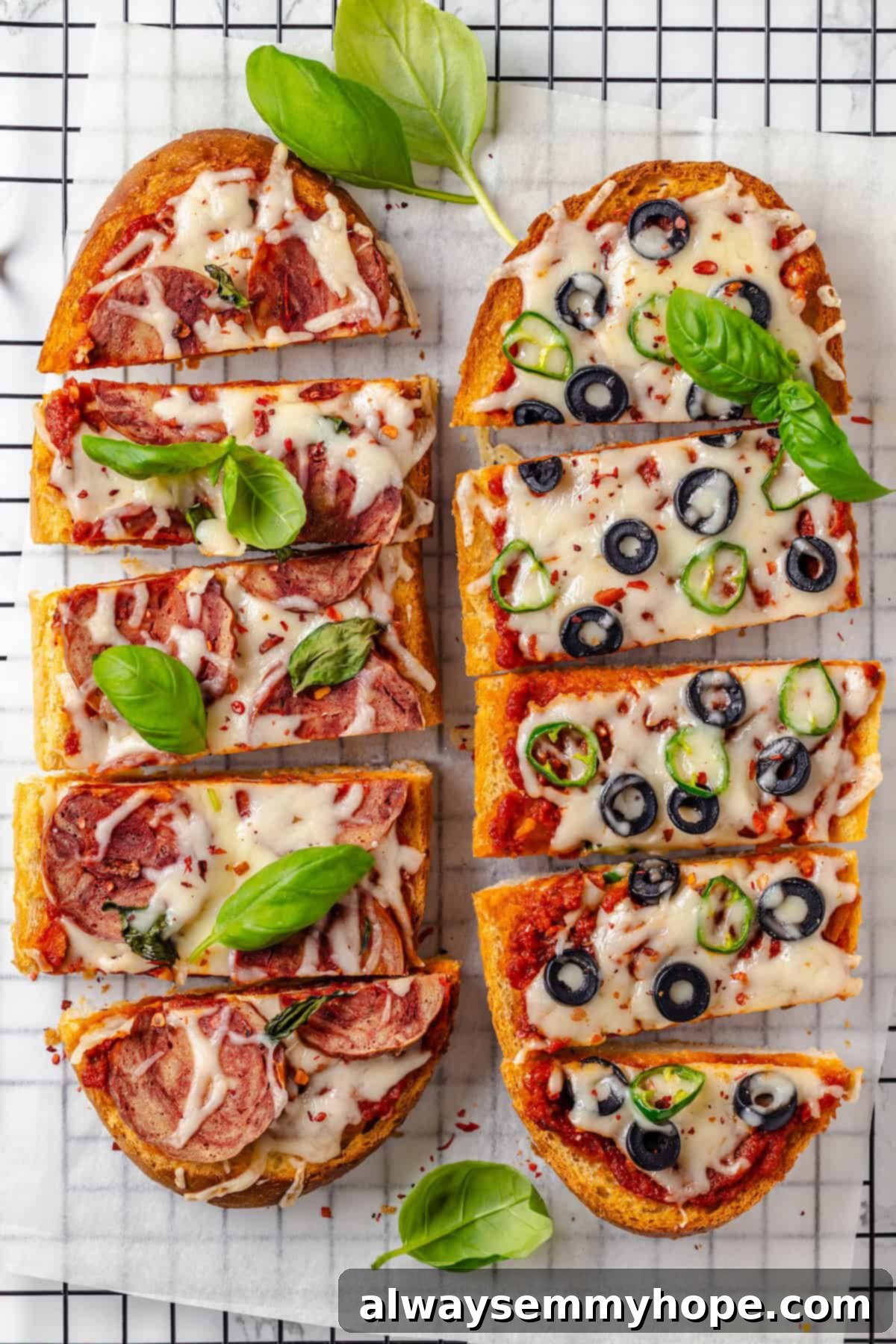 This vegan French Bread Pizza recipe is cheesy, easy and that thick, toasty base puts regular crust to shame. I’ve got two topping options! Overhead view of 2 vegan French bread pizzas on wire rack, freshly baked and ready to serve