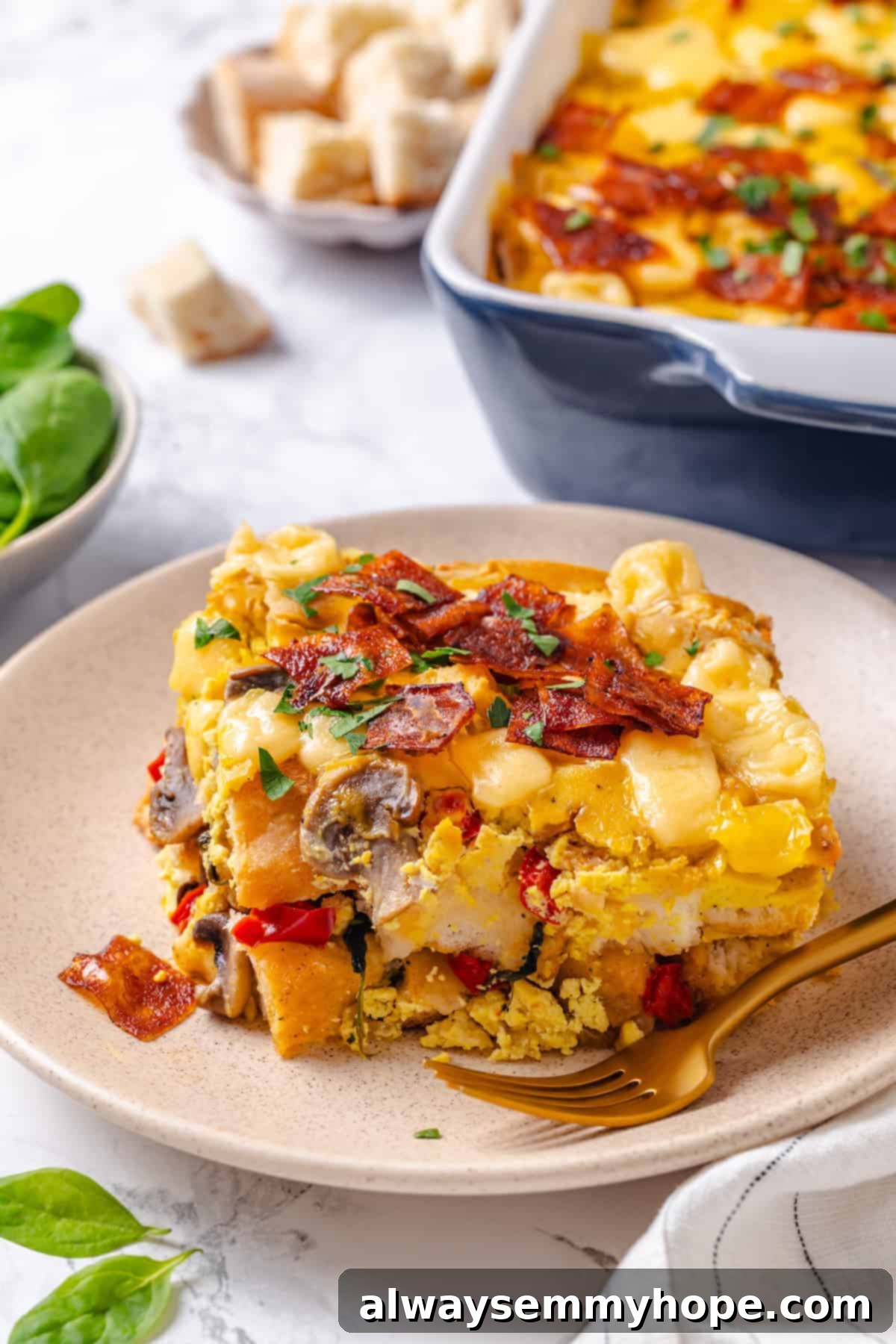 A delectable slice of vegan overnight breakfast strata on a plate, garnished with fresh herbs, ready to be enjoyed with a fork.